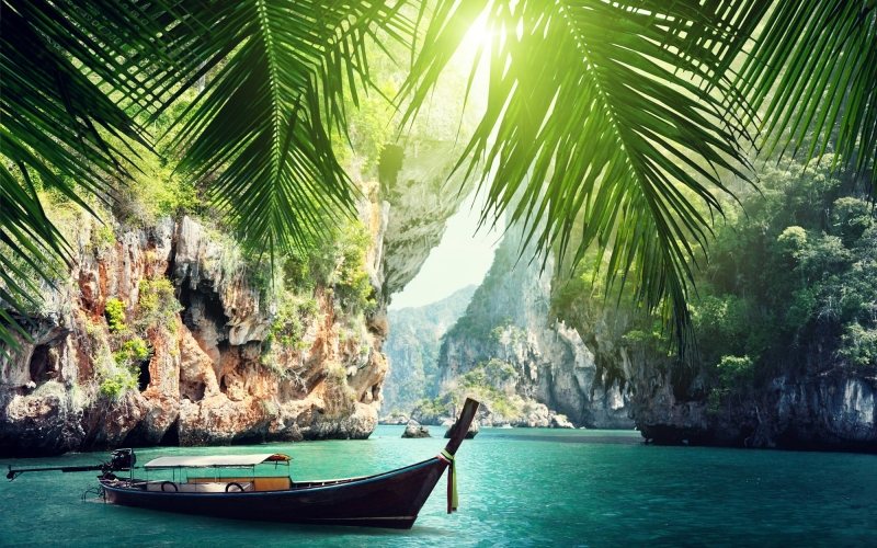 a-long-boat-docked-on-beach-in-krabi-thailand-summers-469733898_3000x2000